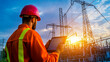 © pornthip - Electrical Engineer Inspecting High Voltage Power Lines with Tablet