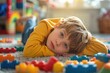 © sergiokat - Portrait of a child with autism playing with colorful building blocks, deeply focused and happy