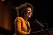 © Rawpixel.com - Black woman speaker on professional stage microphone smiling adult.