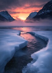 Poster - A sunset over a frozen lake with mountains in the background