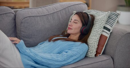 Canvas Print - Calm woman, music and headphones in home for listening to audio, radio and hearing podcast on sofa. Happy person, relax and streaming for sound, multimedia and peaceful subscription in living room