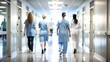 © Mari - 'Nurses in Hospital Hallway Blur' – A soft, blurred background showing nurses walking through a hospital corridor.