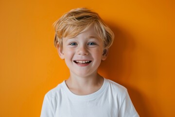 Happy little blonde male kid boy in white tshirt laughing at camera against orange background, Generative AI