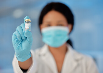 Wall Mural - Woman, hand and scientist with vial at laboratory on vaccine investigation for disease, virus and pandemic. Female person, mask and healthcare specialist with cure in bottle for new covid variant