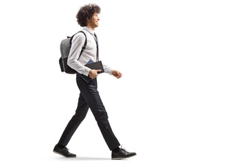 Canvas Print - College student carrying a book and walking