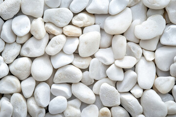 Background of white smooth pebble stones, close up