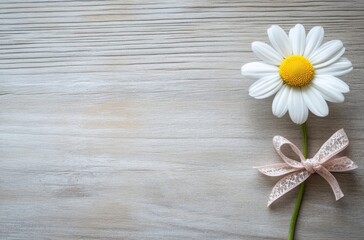 Canvas Print - Daisy Flower with Pink Bow on a Wooden Background