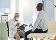 © peopleimages.com - Mask, consulting and doctor with patient history for medical, life insurance or covid test results. Infection, sick and men speaking of checklist in hospital for support, healthcare record or advice