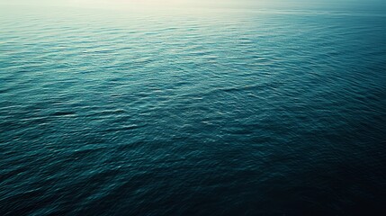 Wall Mural - Photograph of a calm, crystal-clear ocean with a slight blue gradation. Create a calm and simple background.