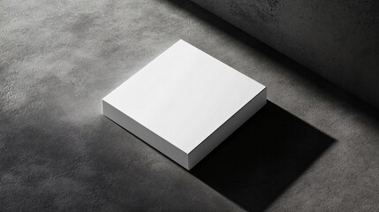 Wall Mural - A single white square, slightly off-center, on a dark grey background with shadows