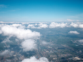 High angle view of Shanghai cityscape in sunny cloudy day, travel concept, go everywhere. Landscape viewed from plane window, passenger view.