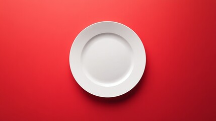 Wall Mural - A white plate is on a red background