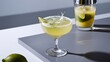 © Kartik - Close up view of alcohol margarita cocktails with lime and shaker on grey surface on white