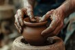 © DKPhoto - A potter uses skilled hands to mold a clay pot on the wheel, highlighting the meticulous craftsmanship and traditional techniques involved in pottery artistry.