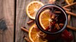 © Kartik - Close up view of hot mulled wine drinks with spices and orange pieces on wooden tabletop