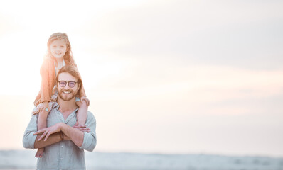 Canvas Print - Father, girl and shoulder carry at beach for travel, bonding and relax with portrait and mockup space. Family, dad and child outdoor at ocean for adventure, tropical holiday or lens flare in Maldives