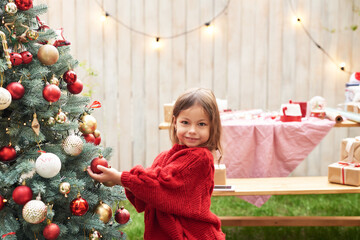 Christmas in July. Family woman mother and child daughter on the background of a Christmas tree
