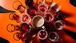 © Kartik - Close up view of arranged empty glasses and mug of beer on orange background