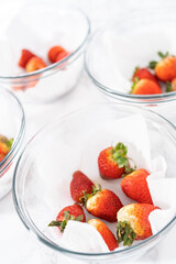 Poster - Fresh and Moldy Strawberries in a Glass Bowl on a White Napkin