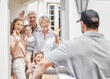 © Flashizzle/peopleimages.com - Delivery man, happy or big family greeting in home for gift, product distribution or good service. Grandparents, hello or courier worker give shipping package, ecommerce order or box to excited kids