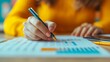 © KN Studio - Focused Analysis: A woman's hand meticulously analyzes financial data with a pen, highlighting the intricacies of business and finance.