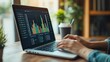© KN Studio - Laptop with Financial Data: A close-up shot of a person's hands typing on a laptop, with a financial chart displayed on the screen. The image conveys a sense of focus, analysis, and the pursuit of fin