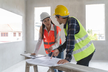 Wall Mural - Concept Teamwork of building construction staff. Project engineer contractor reviewing plan of work with foreman and worker at construction site.