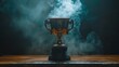 © AndiAzis - Golden trophy with smoke on wooden surface.