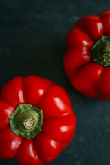 Red bell pepper on black background