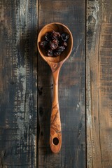 Raisin grain in wooden spoon closeup view