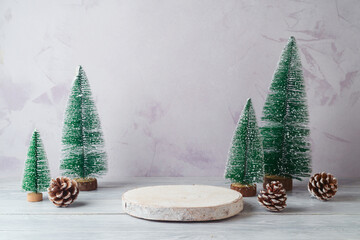 Wall Mural - Empty log podium and and pine tree decoration on white wooden table over bright wall  background. Christmas mock up for design and product display.