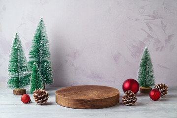 Wall Mural - Empty log podium and and pine tree decoration on white wooden table over bright wall  background. Christmas mock up for design and product display.