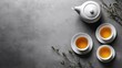 © sknab - Serene Tea Set on Minimalist Grey Background - Overhead View of Teapot, Cup, and Sugar Bowl for Elegant Tea Time Display