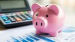 © sarun - Pink piggy bank with a calculator and financial documents, representing budgeting and saving.