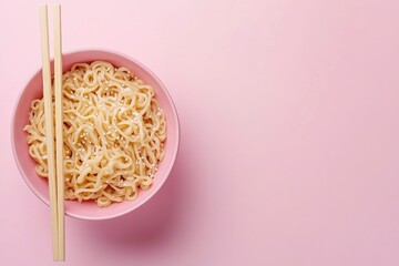 Bowl of Noodles with Sesame Seeds and Chopsticks on Pink Background