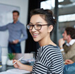 © ArcursForPI/peopleimages.com - Smile, portrait and businesswoman writing notes in office for meeting at hr training for company policy review. Happy, pride and Asian female coordinator in seminar for employee retention strategy