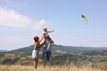 Sticker - Happy family flying kite at field under blue sky