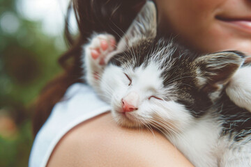 Wall Mural - a woman holding a kitten in her arms