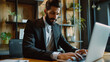 © Hamza - Successful business man in a modern office working on laptop