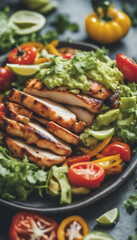 Canvas Print - Healthy southwest style meal of Chicken grilled peppers and onions lettuce tomatoes guacamole fresh