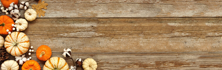 Aufkleber - Fall corner border of pumpkins, leaves and natural decor over a rustic wood banner background. Top down view with copy space. White, brown and orange colors.