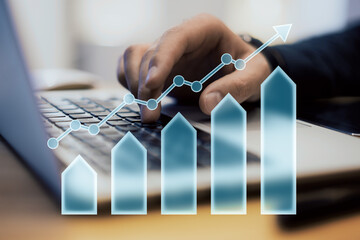 Poster - Hand typing on laptop with upward arrow and bar chart overlay symbolizing growth and financial success.