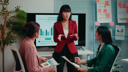 Poster - Businesswoman is presenting marketing data to her two colleagues in the office. They are discussing the results of a recent campaign