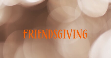 Wall Mural - image of friendsgiving text over spot lights brown background