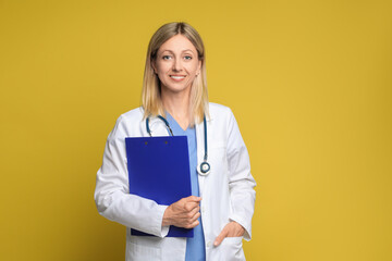 Wall Mural - Portrait of doctor in medical uniform with stethoscope and clipboard on yellow background