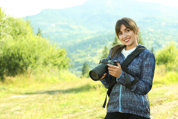 Wall Mural - Photographer with backpack and camera in beautiful mountains. Space for text