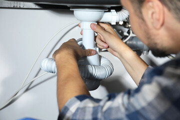 Wall Mural - Professional plumber fixing piping system at home, closeup