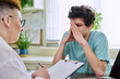© Valerii Honcharuk - Young male patient in therapy with psychologist counselor in office