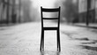 © Parintron - A solitary black chair stands on a deserted street, highlighted by muted tones and a contemplative ambiance.