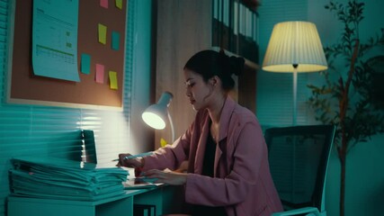 Poster - Young asian businesswoman working late using laptop computer, businesswoman working with serious emotion, overtime work concept